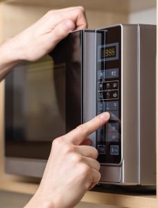 Woman resetting her microwave clock