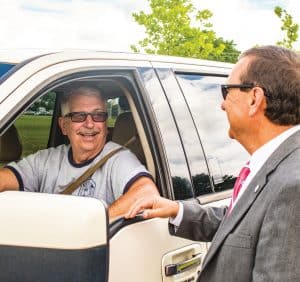 YEC CEO Paul Basha chatting with member Perry Johnston at the Annual Meeting registration drive-thru.