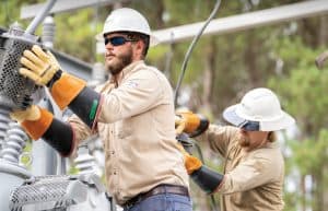 Linemen upgrading a substation are pictured at work.