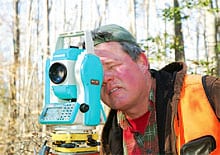 Surveyor Cam Robinson of Baird Engineering lines out new tracts. 