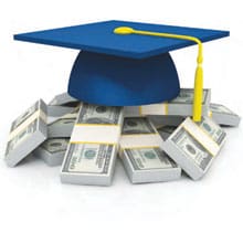 Graduation cap sitting on stacks of cash.